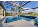 This waterfront home features a screened in pool with an attached spa offering a luxury outdoor space at 711 Windlass Ct, Kissimmee, FL 34746