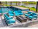 The pool-side patio and seating area offer a fire pit and plenty of comfortable space to enjoy the Florida weather at 711 Windlass Ct, Kissimmee, FL 34746