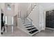 Modern staircase with stainless steel railings leading to the upper level of the home at 711 Windlass Ct, Kissimmee, FL 34746
