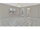 Spacious bedroom with tiled floors, a ceiling fan, and an ensuite bathroom at 7709 Pine Hollow Ct, Orlando, FL 32822