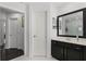 Bathroom features a vanity with sink, mirror, white doors, and tiled flooring at 772 Pickfair Ter, Lake Mary, FL 32746