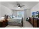 Well-lit bedroom features a ceiling fan, neutral walls, and cozy furnishings at 772 Pickfair Ter, Lake Mary, FL 32746