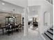 Open-concept dining room and living room with marble floors and staircase at 772 Pickfair Ter, Lake Mary, FL 32746