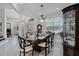 Formal dining room with a chandelier, large window, and elegant furniture at 772 Pickfair Ter, Lake Mary, FL 32746