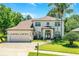 Charming two-story home with a brick driveway, well-manicured lawn, and lush landscaping at 772 Pickfair Ter, Lake Mary, FL 32746