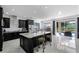 Modern kitchen with dark cabinetry, marble countertops, stainless steel appliances, and backyard view at 772 Pickfair Ter, Lake Mary, FL 32746