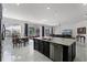 Spacious kitchen with dark cabinets, marble countertops, stainless steel appliances, and open living area at 772 Pickfair Ter, Lake Mary, FL 32746