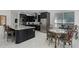 Modern kitchen with dark cabinetry, marble countertops, stainless steel appliances, and a breakfast nook at 772 Pickfair Ter, Lake Mary, FL 32746