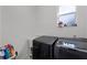Laundry machines in the laundry room with a window and cleaning products nearby at 772 Pickfair Ter, Lake Mary, FL 32746