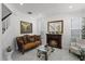 Cozy living room with a decorative fireplace, comfortable seating, and beautiful artwork at 772 Pickfair Ter, Lake Mary, FL 32746