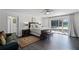 Serene main bedroom with a balcony access, dark wood floors, and a decorative rug at 772 Pickfair Ter, Lake Mary, FL 32746
