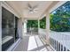 Inviting covered patio with a ceiling fan, perfect for outdoor relaxation and enjoying the surrounding green views at 772 Pickfair Ter, Lake Mary, FL 32746