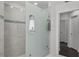 Modern bathroom features a tiled shower with a glass partition and sleek fixtures at 772 Pickfair Ter, Lake Mary, FL 32746
