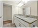 Bathroom with double granite vanity top, tile floors and white cabinets at 7809 Purple Finch St, Winter Garden, FL 34787