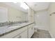 Spacious bathroom with double vanity, granite countertops, and tile flooring at 7809 Purple Finch St, Winter Garden, FL 34787
