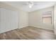 Bright bedroom features a ceiling fan, wood-look floors, and a double closet at 7809 Purple Finch St, Winter Garden, FL 34787