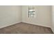 This bedroom features carpeted floors and a bright, sunny window at 7809 Purple Finch St, Winter Garden, FL 34787