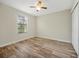 Carpeted bedroom with a window and ceiling fan is bright and airy at 7809 Purple Finch St, Winter Garden, FL 34787
