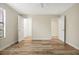 Large bedroom shows two open doors with wood look floors and neutral paint at 7809 Purple Finch St, Winter Garden, FL 34787