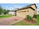 Single-Gathering home with a spacious garage, brick paved driveway, and a well-manicured lawn at 7809 Purple Finch St, Winter Garden, FL 34787