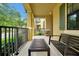 Inviting front porch with a bench, a table and a view of the neighborhood at 7809 Purple Finch St, Winter Garden, FL 34787