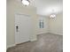 Bright, airy living room with tile flooring and a front door at 7809 Purple Finch St, Winter Garden, FL 34787