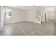 Open living room with tile flooring, a ceiling fan, and stairs to the second floor at 7809 Purple Finch St, Winter Garden, FL 34787