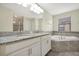 Elegant bathroom featuring double vanity with granite countertops, soaking tub, and tiled backsplash at 7809 Purple Finch St, Winter Garden, FL 34787