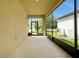 Screened in porch with an outdoor fan and a view of the driveway at 7809 Purple Finch St, Winter Garden, FL 34787