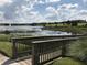 Scenic walking path with a wooden bridge, lush greenery, and a tranquil lake view, perfect for leisurely strolls at 7809 Purple Finch St, Winter Garden, FL 34787