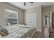 Comfortable bedroom with a ceiling fan, window, and closet for ample storage space at 8208 Westminster Abbey Blvd, Orlando, FL 32835