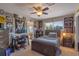 Cozy bedroom with unique decor, a comfortable bed, a study desk, and access to an en-suite bathroom at 8208 Westminster Abbey Blvd, Orlando, FL 32835