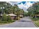 The gated community entrance with brick guardhouse offers security and a welcoming entrance at 8208 Westminster Abbey Blvd, Orlando, FL 32835