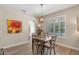 Cozy dining area with views to a pool and a vibrant art piece hanging on the wall at 8208 Westminster Abbey Blvd, Orlando, FL 32835