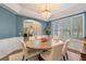 Light-filled dining room with round table and seating for six featuring a view to the home's entry at 8208 Westminster Abbey Blvd, Orlando, FL 32835