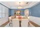 Stylish dining room with blue walls, a chandelier, and seating for six, perfect for formal dinners at 8208 Westminster Abbey Blvd, Orlando, FL 32835