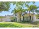 Elegant two-story home boasts a lush lawn, palm trees, and a spacious three-car garage at 8208 Westminster Abbey Blvd, Orlando, FL 32835