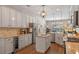 Well-lit kitchen showcases stainless appliances, granite countertops, and wine cooler, perfect for entertaining at 8208 Westminster Abbey Blvd, Orlando, FL 32835