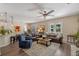 Open-concept living area with leather sofas, hardwood floors, and seamless flow to the kitchen and dining at 8208 Westminster Abbey Blvd, Orlando, FL 32835