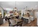 Open-concept living space with kitchen island, dining area, and a cozy living room with a fireplace at 8208 Westminster Abbey Blvd, Orlando, FL 32835