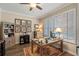 Well-lit home office with plantation shutters, a wooden desk, and built-in bookcase at 8208 Westminster Abbey Blvd, Orlando, FL 32835