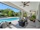 Outdoor patio with a refreshing pool, comfortable seating, and lush landscaping, perfect for relaxation and entertaining at 8208 Westminster Abbey Blvd, Orlando, FL 32835
