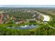 Aerial view of a community featuring lush landscaping, serene lakes, and inviting community spaces at 8404 Secret Key Cv, Kissimmee, FL 34747