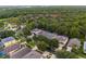 Aerial view showcases a community with mature trees, landscaped streets, and well-maintained homes at 8404 Secret Key Cv, Kissimmee, FL 34747
