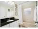 Bathroom featuring a granite countertop vanity, framed artwork and a shower-tub combo at 8404 Secret Key Cv, Kissimmee, FL 34747