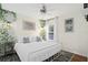 Bright bedroom with a white bed, ceiling fan, and lattice accent wall with climbing plants at 8404 Secret Key Cv, Kissimmee, FL 34747