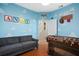 A creatively designed bedroom featuring Andy-themed decor, foosball table, and cozy seating at 8404 Secret Key Cv, Kissimmee, FL 34747