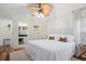 Bright bedroom featuring a neutral color palette, en-suite bath, and stylish ceiling fan at 8404 Secret Key Cv, Kissimmee, FL 34747