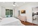 Serene bedroom with view of pool, light pink dresser, and doorway to the kitchen at 8404 Secret Key Cv, Kissimmee, FL 34747