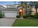 Charming two-story home features a well-maintained lawn, attached two-car garage and manicured landscaping at 8404 Secret Key Cv, Kissimmee, FL 34747